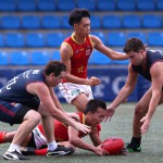 Team China show their AFL spirit by playing Hong Kong Dragons, reports South China Morning Post China's Zheng Yifeng beats the Dragons to the ball. Photo: K.Y. Cheng. Photo, South China Morning Post.